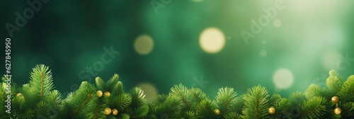Christmas tree branches on golden glitters bokeh wide background banner