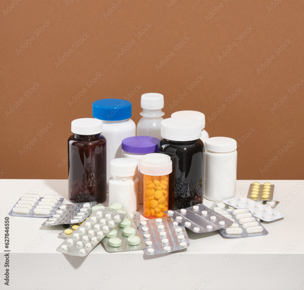 Large assorted pharmaceutical medicine pills, tablets, capsules. Different vitamins and supplements. Medical jars of different colors and shapes. Large assorted pharmaceutical medicine pills, tablets, capsules. Different vitamins and supplements. Medical jars of different colors and shapes.