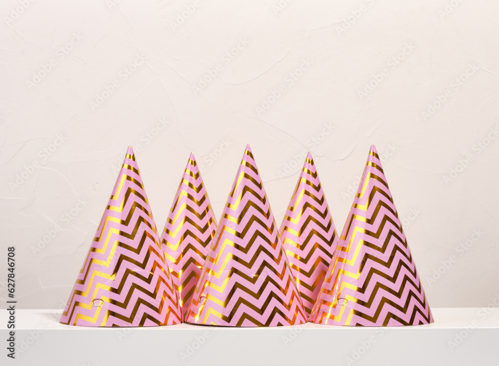Fototapeta premium Some shiny, colorful birthday party gift hats. Celebration mood.