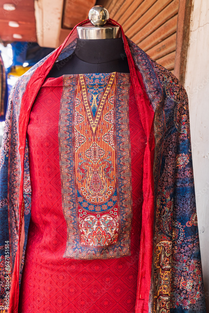 Traditional women's dress for sale at a market in Srinagar.