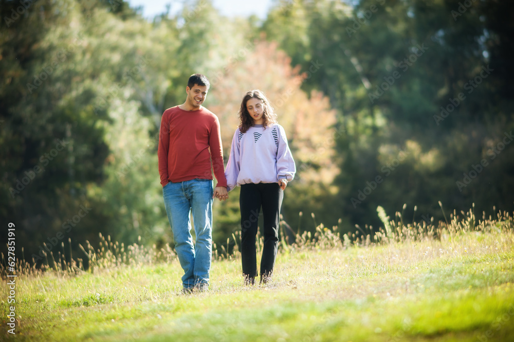 Falling in love. Romantic couple enjoying in meadow walk together in nature outdoor. Love, relationship and romance concept. Girlfriend and boyfriend dating