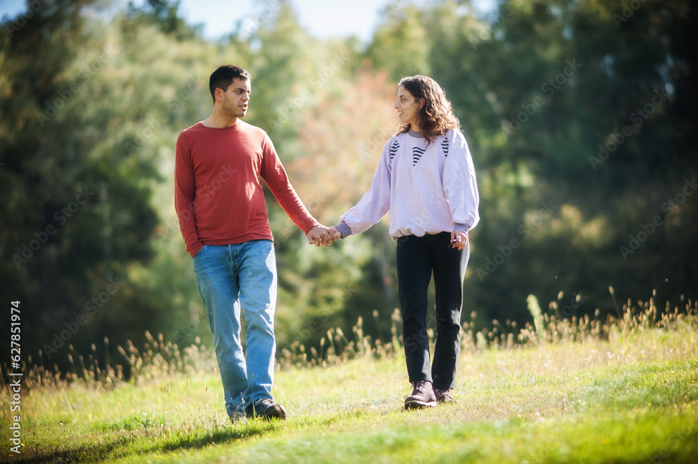 Falling in love. Romantic couple enjoying in meadow walk together in nature outdoor. Love, relationship and romance concept. Girlfriend and boyfriend dating Falling in love. Romantic couple enjoying in meadow walk together in nature outdoor. Love, relationship and romance concept. Girlfriend and boyfriend dating