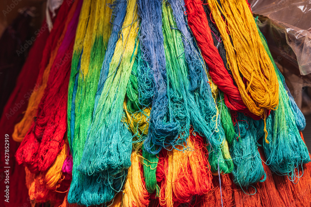 Fototapeta premium Birghtly colored yarn for sale at a market in Srinagar.