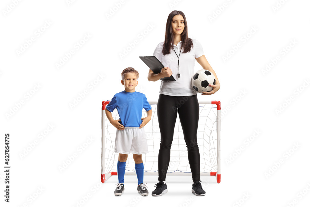 Fototapeta premium Boy and a female football coach posing in front of a mini goal