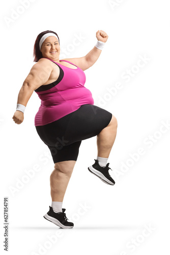 Young smiling overweight woman training in sportswear