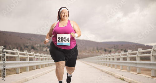 Overweight woman running a marathon