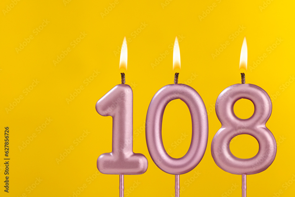 Birthday candle number 108 - Birthday celebration on yellow background Birthday candle number 108 - Birthday celebration on yellow background