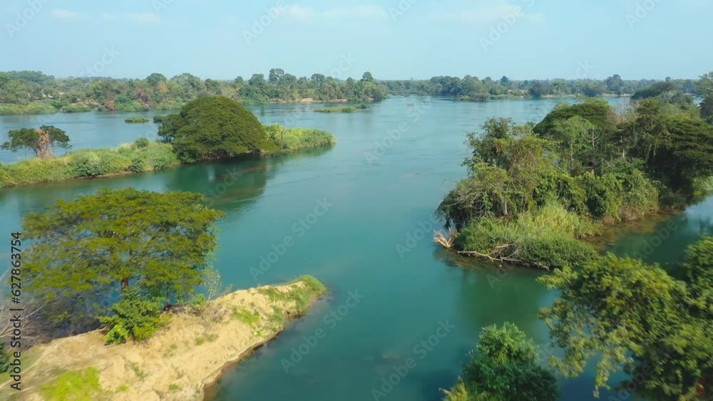 Aerial travelling over the Mekong river in Don Det island, Laos. Beautiful water around islands and traditional lao boats. Aerial travelling over the Mekong river in Don Det island, Laos. Beautiful water around islands and traditional lao boats.