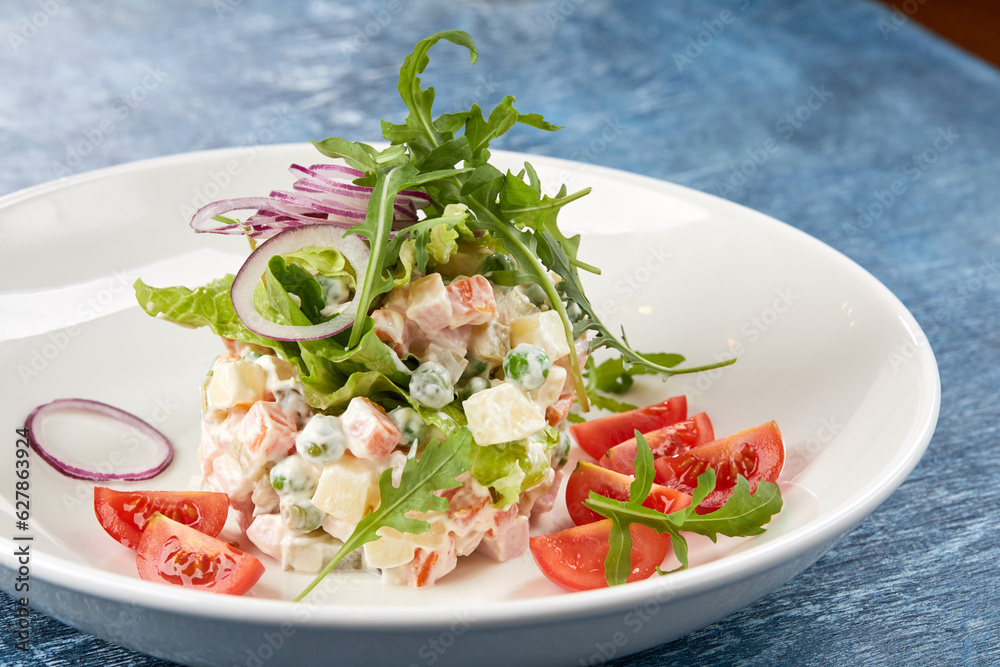 russian salad on the white plate russian salad on the white plate