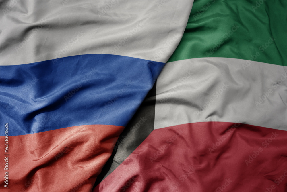big waving realistic national colorful flag of russia and national flag of kuwait .