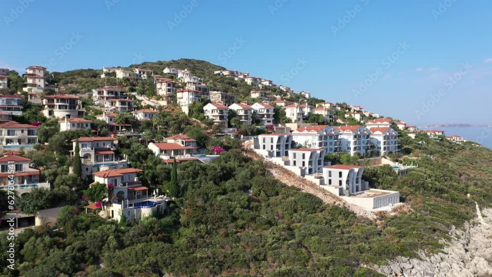 Summer houses with sea view and swimming pool clustered on a hill in Cukurbag Peninsula in Kas, Turkey. White houses and hotels overlooking the Mediterranean Sea
Summer houses with sea view and swimming pool clustered on a hill in Cukurbag Peninsula in Kas, Turkey. White houses and hotels overlooking the Mediterranean Sea
