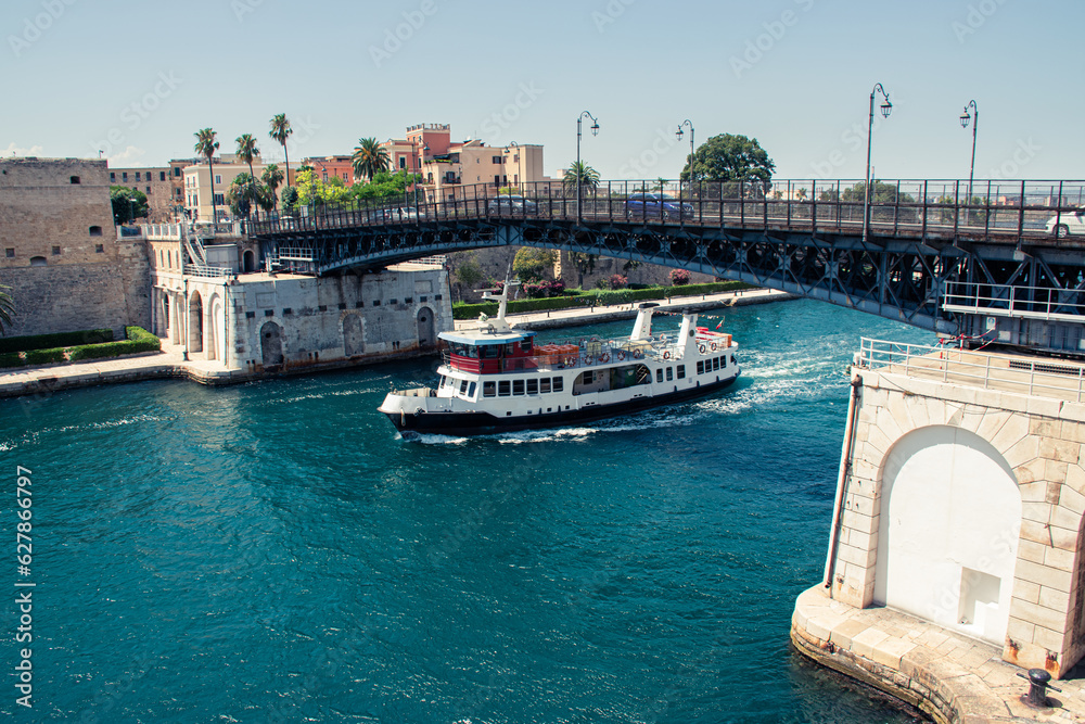 Boat going under a bridge, Ponte Girevole, in Taranto, Italy.