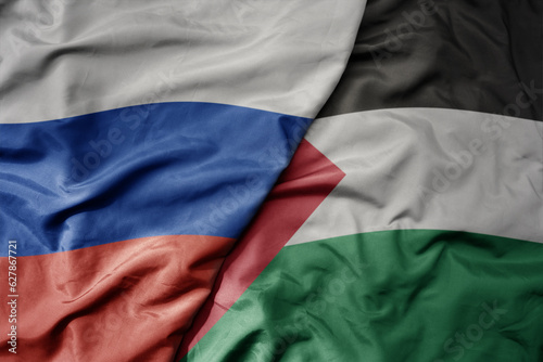 big waving realistic national colorful flag of russia and national flag of palestine .