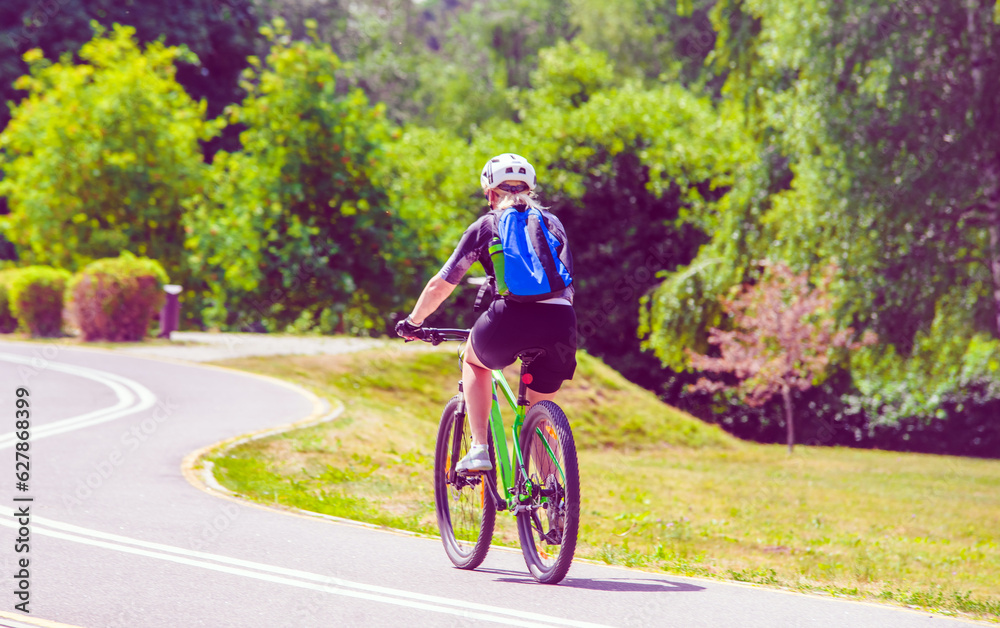Fototapeta premium Cyclist ride on the bike path in the city Park