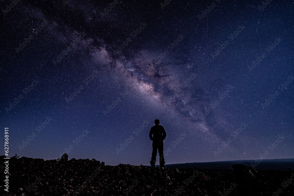 Silhouette of Men / boy on the Milky Way. Stargazing at  Mauna Loa Observatory Road, Big Island Hawaii. Starry night sky,  galaxy astrophotography. 