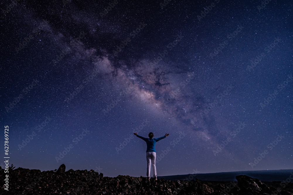 Woman on the Milky Way. Stargazing at  Mauna Loa Observatory Road, Big Island Hawaii. Starry night sky,  galaxy astrophotography. 