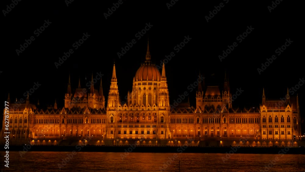 Hungarian Parliament at night. Beautiful building at night illuminated from the side of the river. Hungarian Parliament at night. Beautiful building at night illuminated from the side of the river.