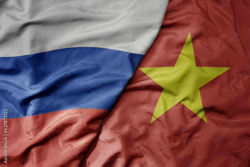 big waving realistic national colorful flag of russia and national flag of vietnam .