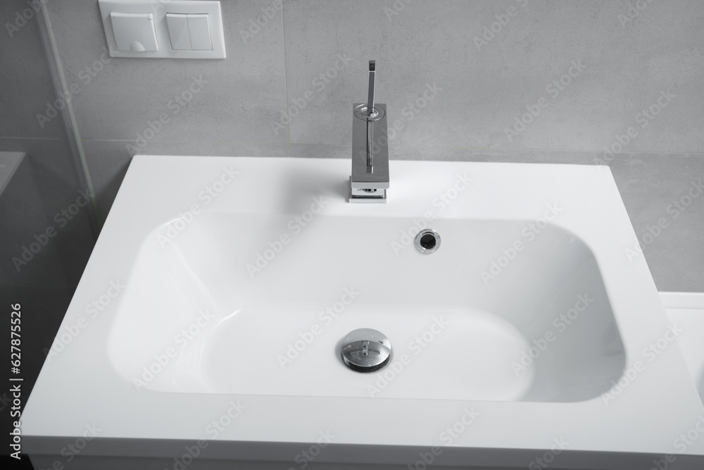 Fototapeta premium Washbasin and chrome faucet in the bathroom
