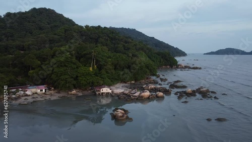 Scenic landscape with a beach and lush forest at Permatang Damar Laut photo