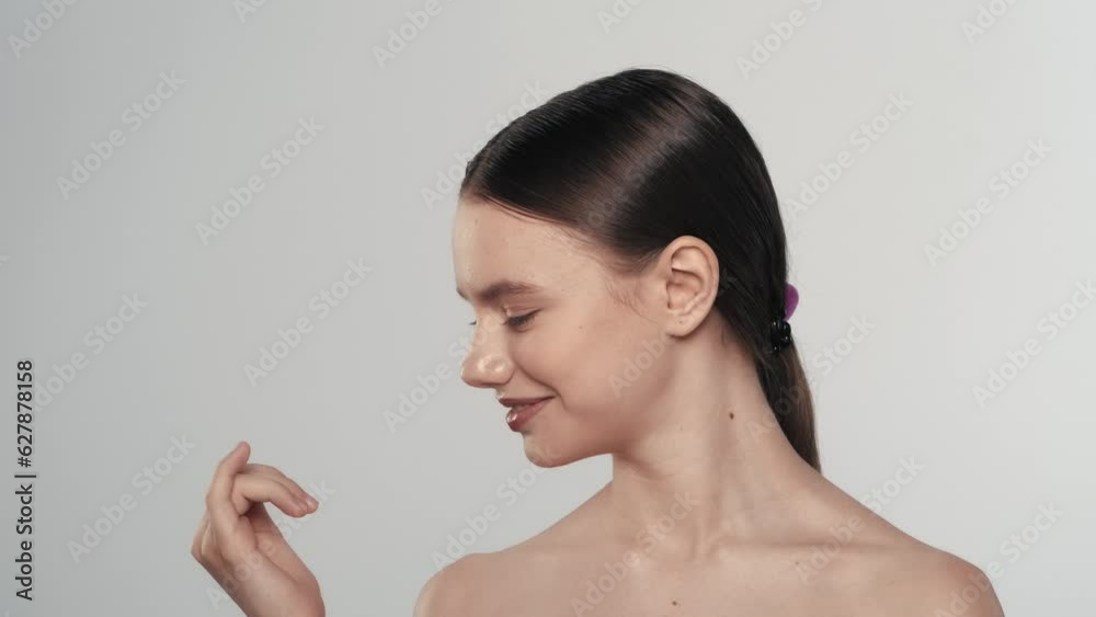 Attractive young girl model looking at her hand and nails, smiling widely. Slow motion Attractive young girl model looking at her hand and nails, smiling widely. Slow motion