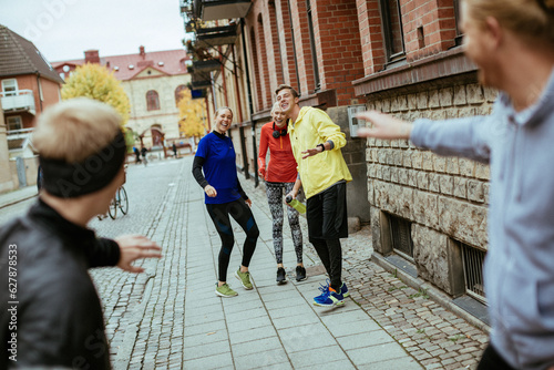 Young people jogging on a city street together © Geber86