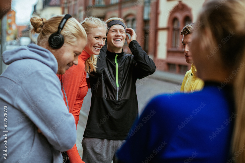 Young people getting ready to go jogging in the city together