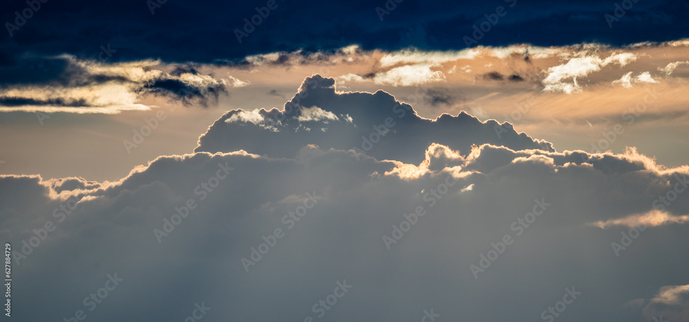 Wide Shot of Rolling Clouds Backlit By Sunset