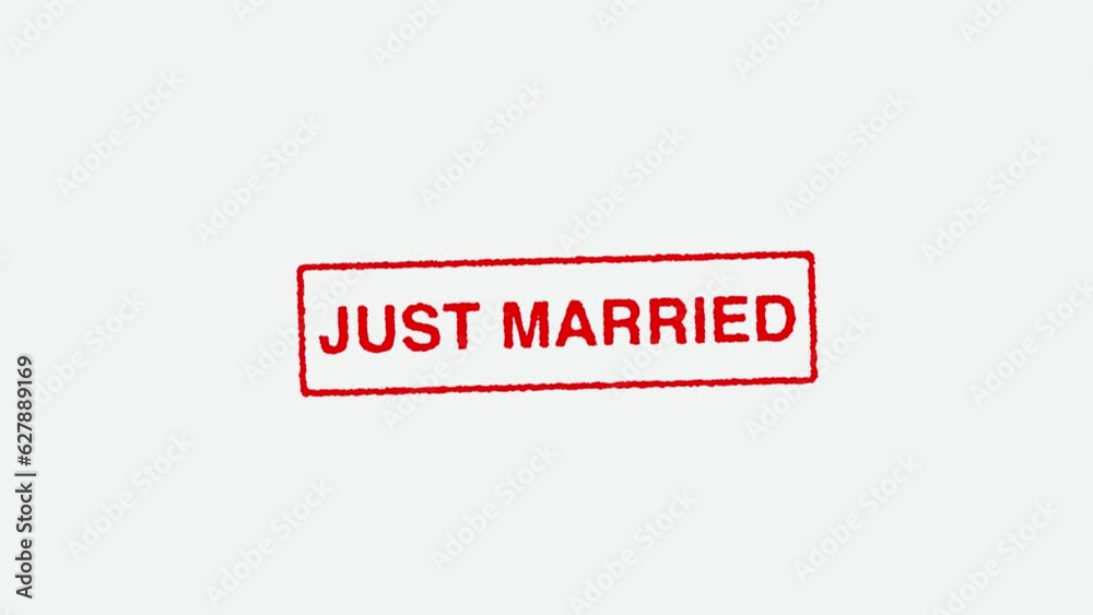 Close Up Real Hand Stamping Just Married Stamp on White Background Close Up Real Hand Stamping Just Married Stamp on White Background