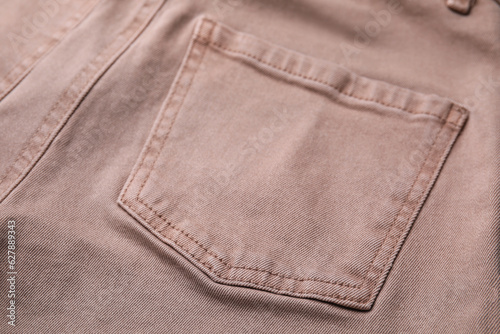 Beige jeans with pockets as background, closeup