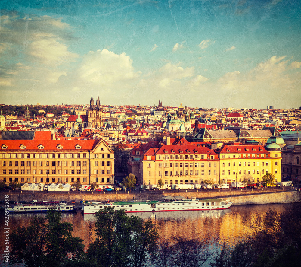 Vintage retro hipster style travel image of aerial view of Prague and Vltava river on sunset, Czech Republic with grunge texture overlaid