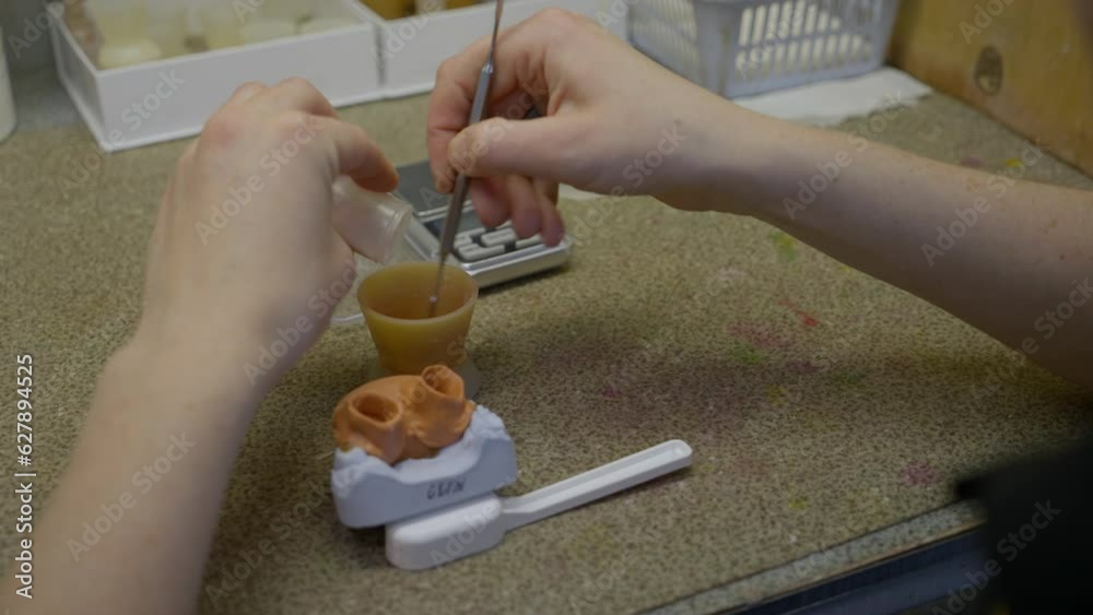 Plaster Toothpaste Making the dental plaster mixture inside of the small plastic cup ...