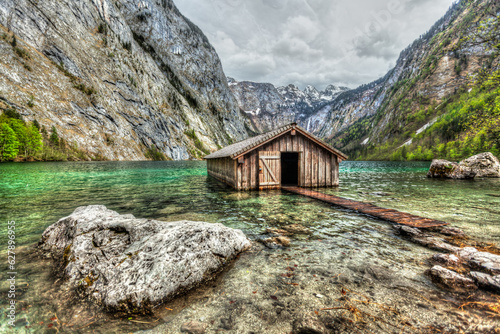 Boat dock hangar on Obersee mountain lake in Alps