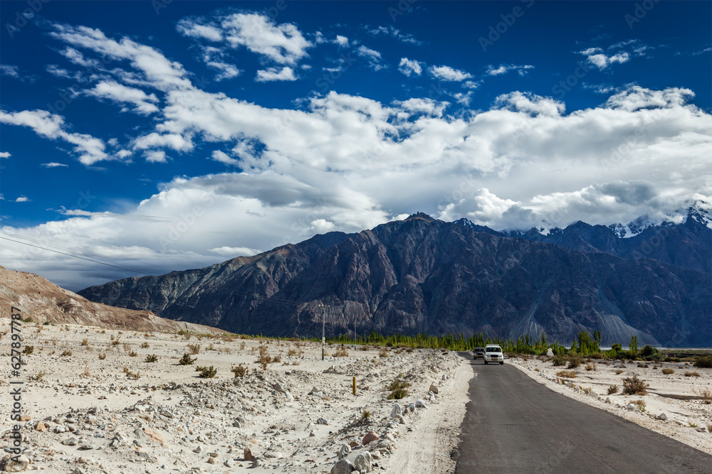 Asphalt road in Himalayas with cars. Nubra valley, Ladakh, India