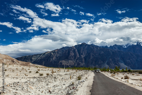 Asphalt road in Himalayas with cars. Nubra valley, Ladakh, India