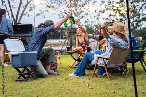 Group of diverse friend having outdoors camping party together in tent. 