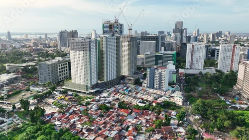 Aerial shot of the poor neighborhoods mixed in with new modern high-rises in Cebu City Philippines. photo
