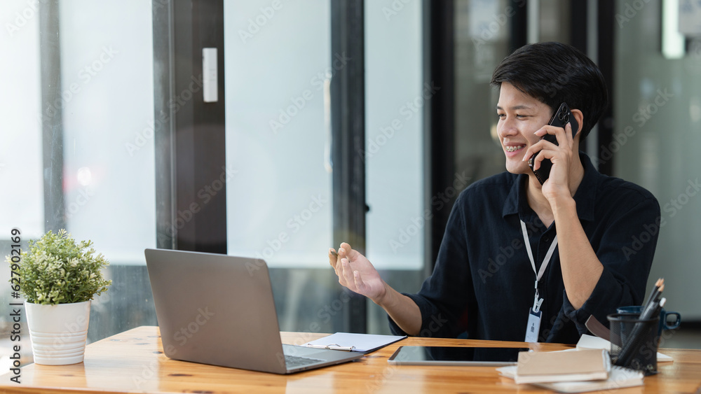 young businessman having document and pencil in hands, speaking on smart phone about important things at desk young businessman having document and pencil in hands, speaking on smart phone about important things at desk