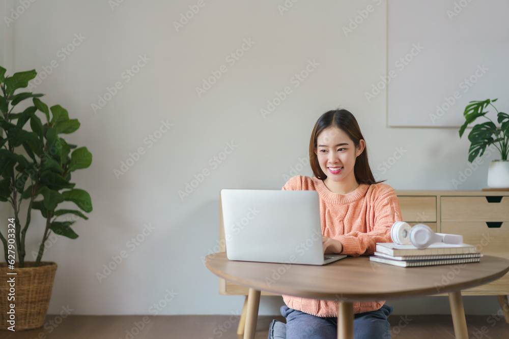 Women sitting on the floor and working to typing business data on laptop in lifestyle at home Women sitting on the floor and working to typing business data on laptop in lifestyle at home