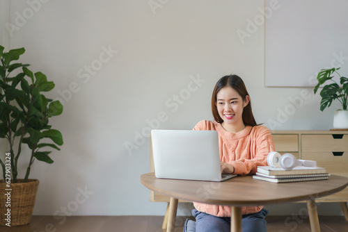 Women sitting on the floor and working to typing business data on laptop in lifestyle at home