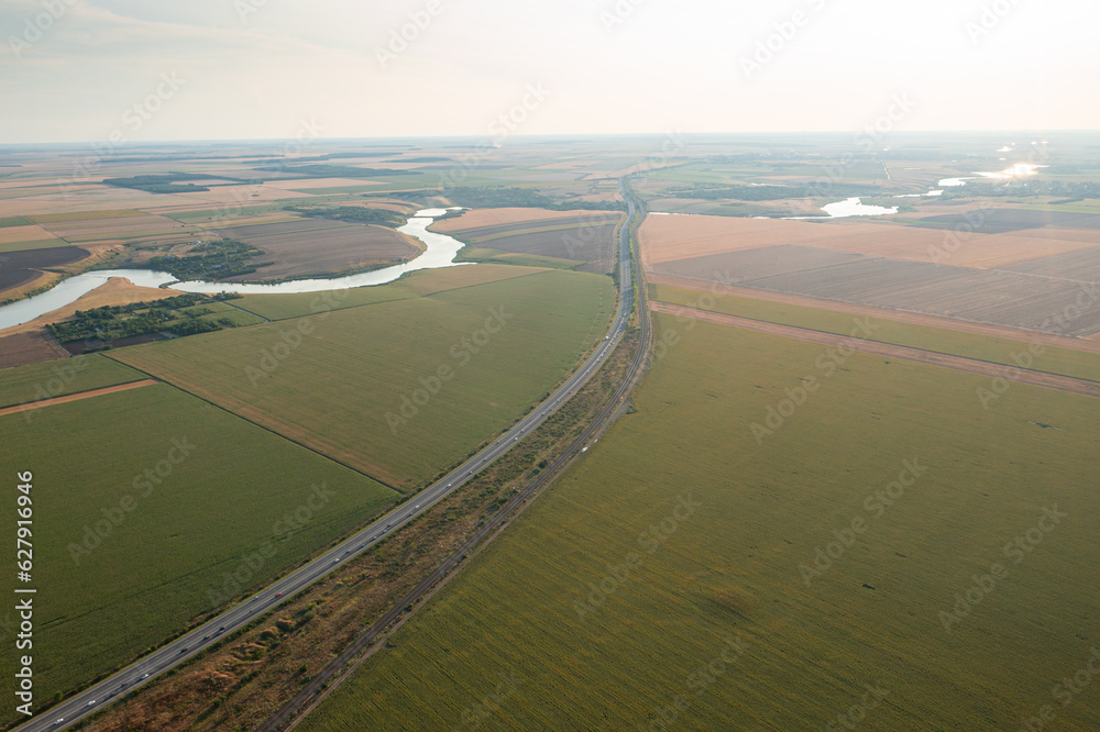 Aerial view over A2 highway road in Romania between Bucharest and Constanta with rush hour traffic. Agriculture field landscape. Transportation industry in Romania.