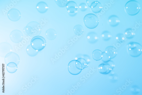 Beautiful Transparent Blue Soap Bubbles Floating in The Air. White Space, Abstract Fun Background, Blue Gradient Blurred Background, Refreshing of Soap Suds Bubbles Water.