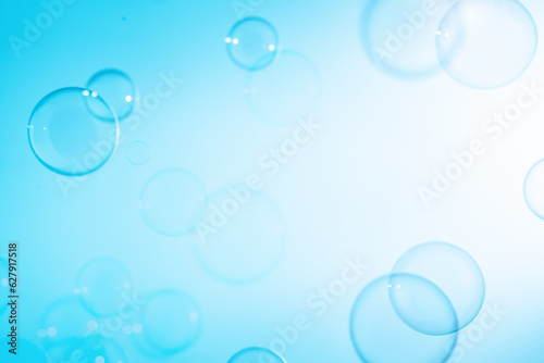 Refreshing of Soap Suds Bubbles Water. Abstract Fun Background, Beautiful Transparent Shiny Blue Soap Bubbles Floating in The Air. Blank White Space, Blue Gradient Blurred Background.