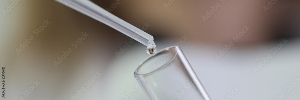 Laboratory diagnostic doctor dripping drop of liquid into test tube with blood closeup Laboratory diagnostic doctor dripping drop of liquid into test tube with blood closeup
