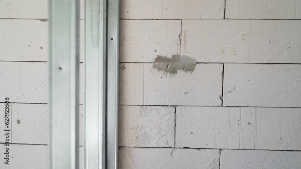 Wall made of aerated concrete bricks and a frame for a plasterboard wall made of metal profiles Wall made of aerated concrete bricks and a frame for a plasterboard wall made of metal profiles