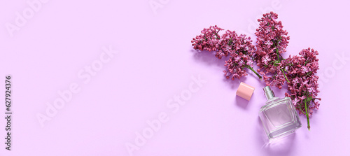 Fotografie, Obraz Beautiful lilac flowers with bottle of perfume on purple background with space f