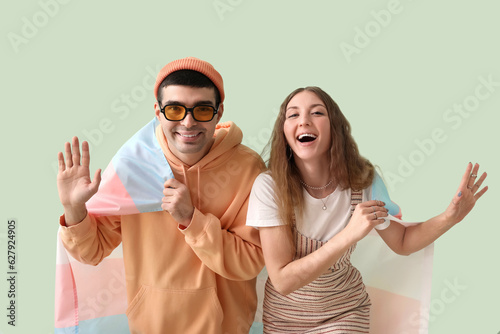 Happy young couple with tra...