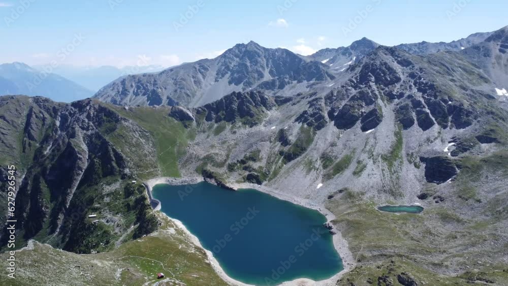 idyllic deep blue mountain lake in the middle of the swiss alps (illsee in valais) with sunny skies idyllic deep blue mountain lake in the middle of the swiss alps (illsee in valais) with sunny skies