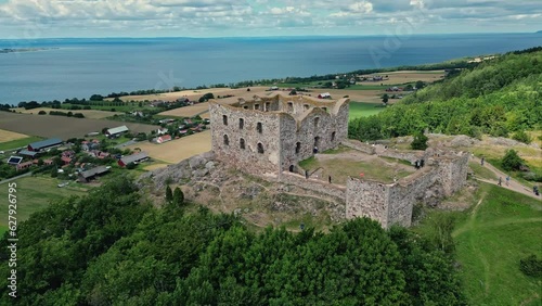 Aerial of the Brahehus Castle, a stone castle built in the 1600s, Småland, Sweden. In the background is Vättern Lake. Drone orbit shot photo