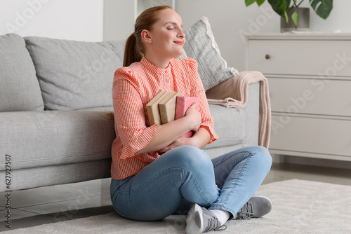 Happy young woman with book...